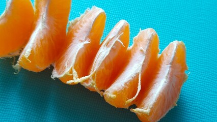 tangerine slices on a blue textured background