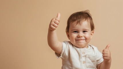 Cheerful Toddler Giving Thumbs Up on Solid Beige Background. Copy space.