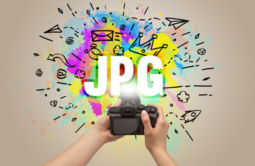 Close-up of a hand holding digital camera with abstract drawing