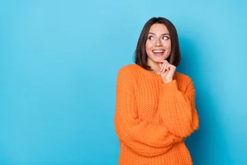 Tapeten Portrait of attractive funny cheerful girl making decision copy empty blank space isolated over bright blue color background © deagreez