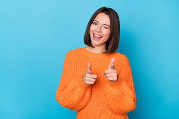 Portrait of attractive flirty funny cheerful girl winking pointing forefingers at you isolated over vibrant blue color background - obrazy, fototapety, plakaty