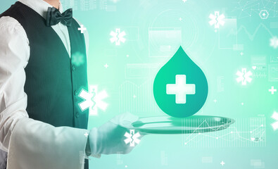 Handsome young waiter in tuxedo holding healthcare icons on tray