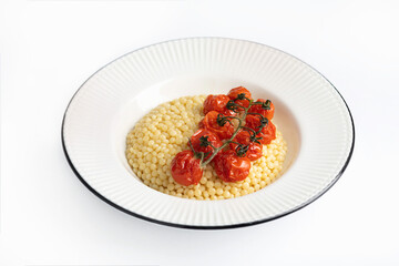 Ptitim with baked cherry tomatoes on a white background