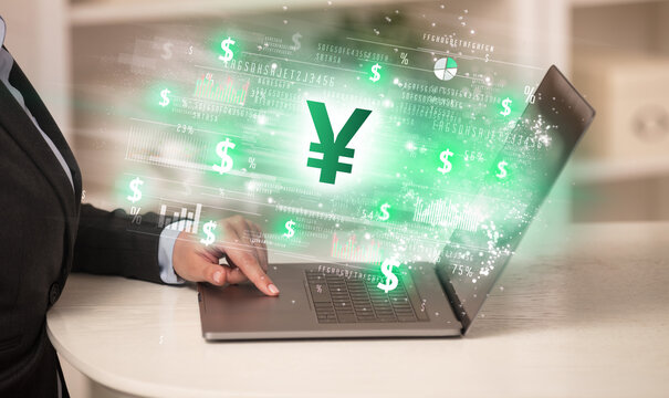 Young man watching stock market on laptop