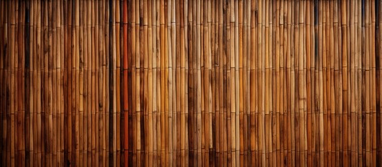 An detailed view showcasing a bamboo fence with a striking red pole standing out within the natural...