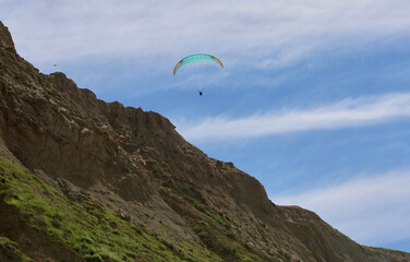 paraglider sailing along the Pacific coastline