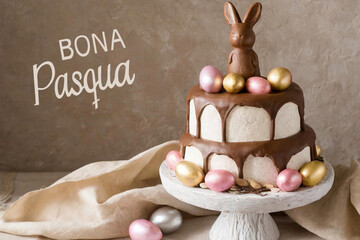 Happy easter text in catalan with cake with easter eggs and chocolate bunny on top.
 - obrazy, fototapety, plakaty