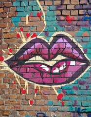 kiss Graffiti on a Brick Wall.