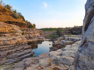 A beautiful lake surrounded by rocky mountain at Chidiya Bhadak, Indore, Madhya Pradesh, India.