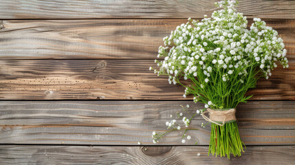 a bouquet of baby's breath sitting on top of a wooden table next to a vase of baby's breath.