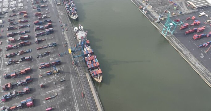 Aerial top down on container ship in the port of Antwerp, Belgium. Port full of containers rady for loading and unloading.