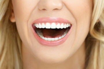 Close-up Close-up of the face of a beautiful young woman smiling with pink lips and soft blonde hair - Young woman laughing