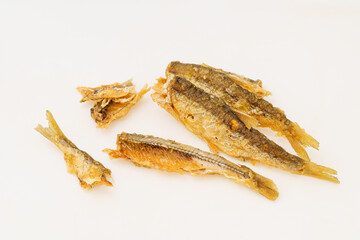 Fried small river fish on white background