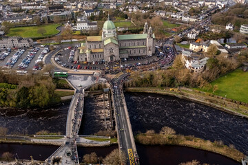 St Patrick's day parade in Galway city. Parade crossing the river on a sunny day
