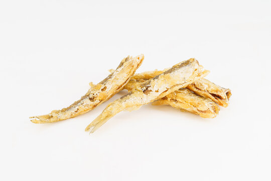 Fried small river fish on white background