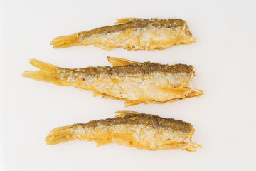Fried small river fish on white background