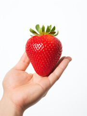 Obraz premium Holding a strawberry in his hand, against a white background сreated with Generative Ai