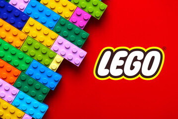 Naklejka premium Close up of colorful Lego blocks with the Lego logo. Illustrative editorial