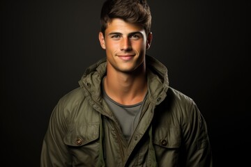 Obraz premium A man in a green jacket posing for a picture