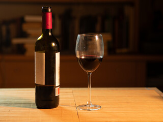 Glass and bottle of red wine ready to be drunk
