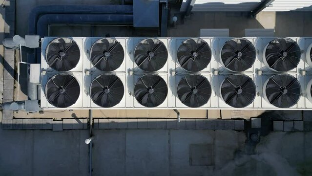 The cooling units are industrial or air-conditioning, which are used in the summer for cooling the premises, with fans on the roof of the storage hall, mainly for industrial operations, high angle
