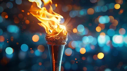 Foto op Canvas Torch with vibrant flame against a blurred blue background. Fire concept with bokeh lights for design and print. © Andrey