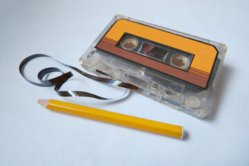 Retro audio cassette and the pencil to rewind the magnetic data carrier.