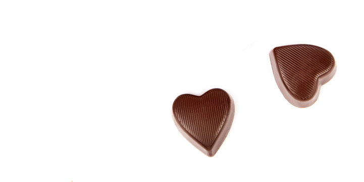 Chocolate candies isolated on white. Free space for text. Wide photo.