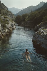 A man swimming in the middle of a river, suitable for outdoor and recreational concepts