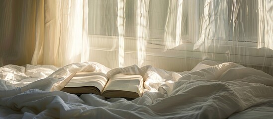 a open book placed on a bed with white linen