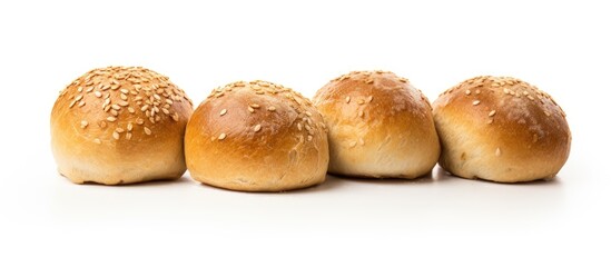 Four bread buns with sesame seeds on white backdrop