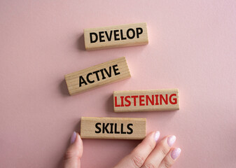 Listening skills symbol. Concept word Develop active listening skills on wooden blocks. Beautiful...