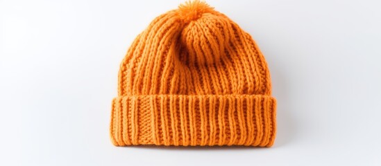 Close-up of an orange knit hat on a white surface