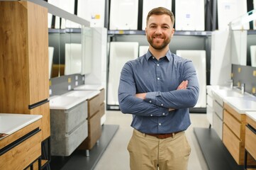 Portrait of salesperson in bathroom store. Happy man works in bath store. Sales occupation