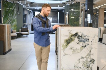 man choosing ceramic tiles and utensils for his home bathroom