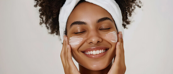 Woman with a smile in a spa relaxing, taking care of her face and having peace of mind.