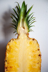 Half of a juicy pineapple cut with leaves