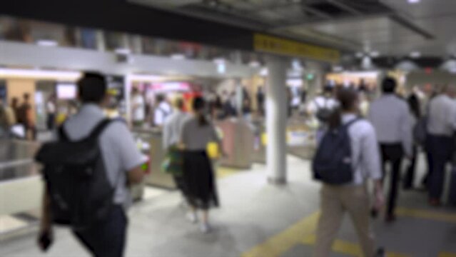 Blurred Business People and Salarymen in Suits and Dress Shirts at Tokyo Train Station in Hurry During Rush Hour