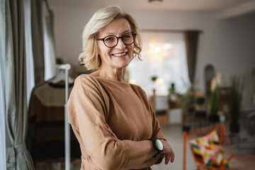 Portrait of one mature blonde caucasian woman with eyeglasses at home