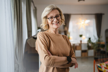 Portrait of one mature blonde caucasian woman with eyeglasses at home