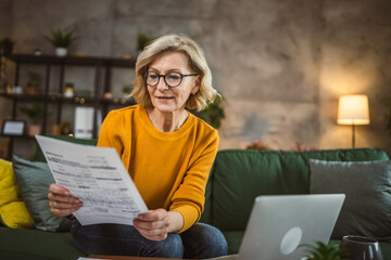 mature caucasian woman use laptop computer at home for work on project