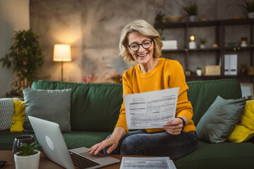 mature caucasian woman use laptop computer at home for work on project