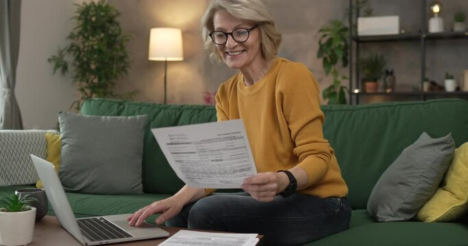 mature caucasian woman use laptop computer at home for work on project