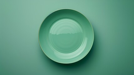 Minimalist green plate on a textured green background. Simplicity captured with an empty green dish on a monochromatic backdrop. Aesthetic of minimalism with a lone green plate on a green surface.