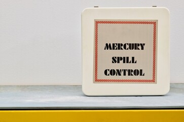 Closed Mercury spill control kit box on shelf with copy space, hazardous danger science laboratory safety equipment concept.