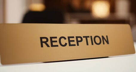 Extreme close up of luxury modern hospitality industry resort check in reception counter sign....