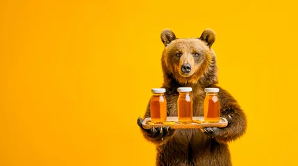Foto op Plexiglas a bear presents jars of honey on a tray - yellow background © Fox_Dsign