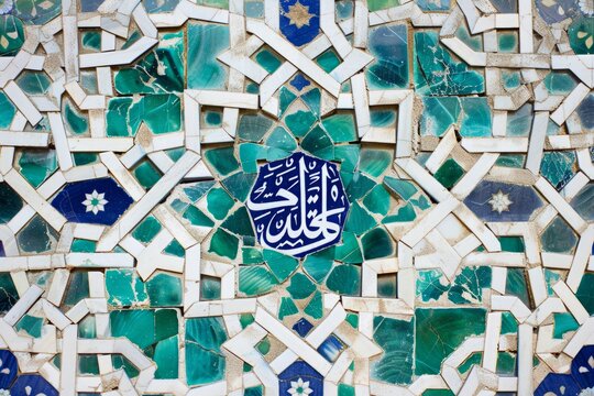 A closeup of an Islamic geometric pattern with blue and green tiles, featuring traditional Arabic calligraphy in the center Generative AI