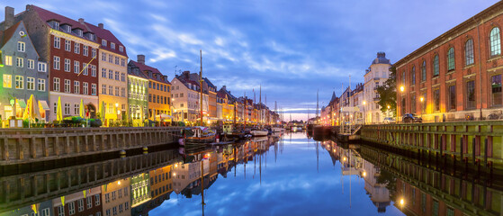 Panorama of Nyhavn with colorful facades of old houses and ships in Old Town of Copenhagen, Denmark. - 765245945