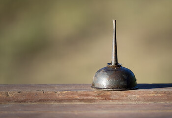 old and small oil can covered in oil and dirt with ample copy space